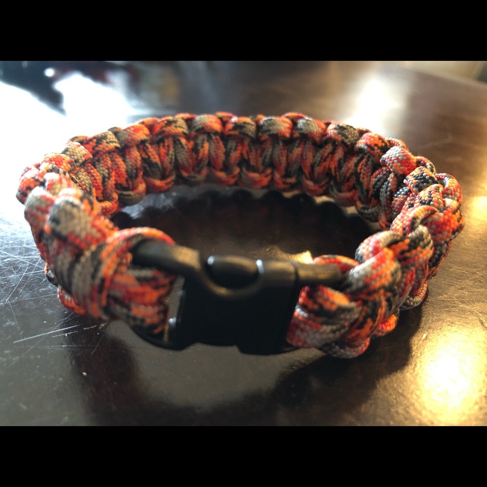 A nine inch orange, black & gray paracord bracelet